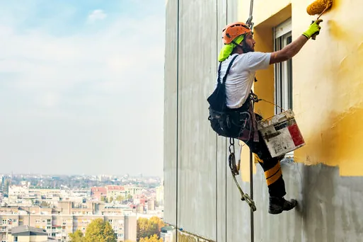 Rope access painter on a Charlotte mid-rise